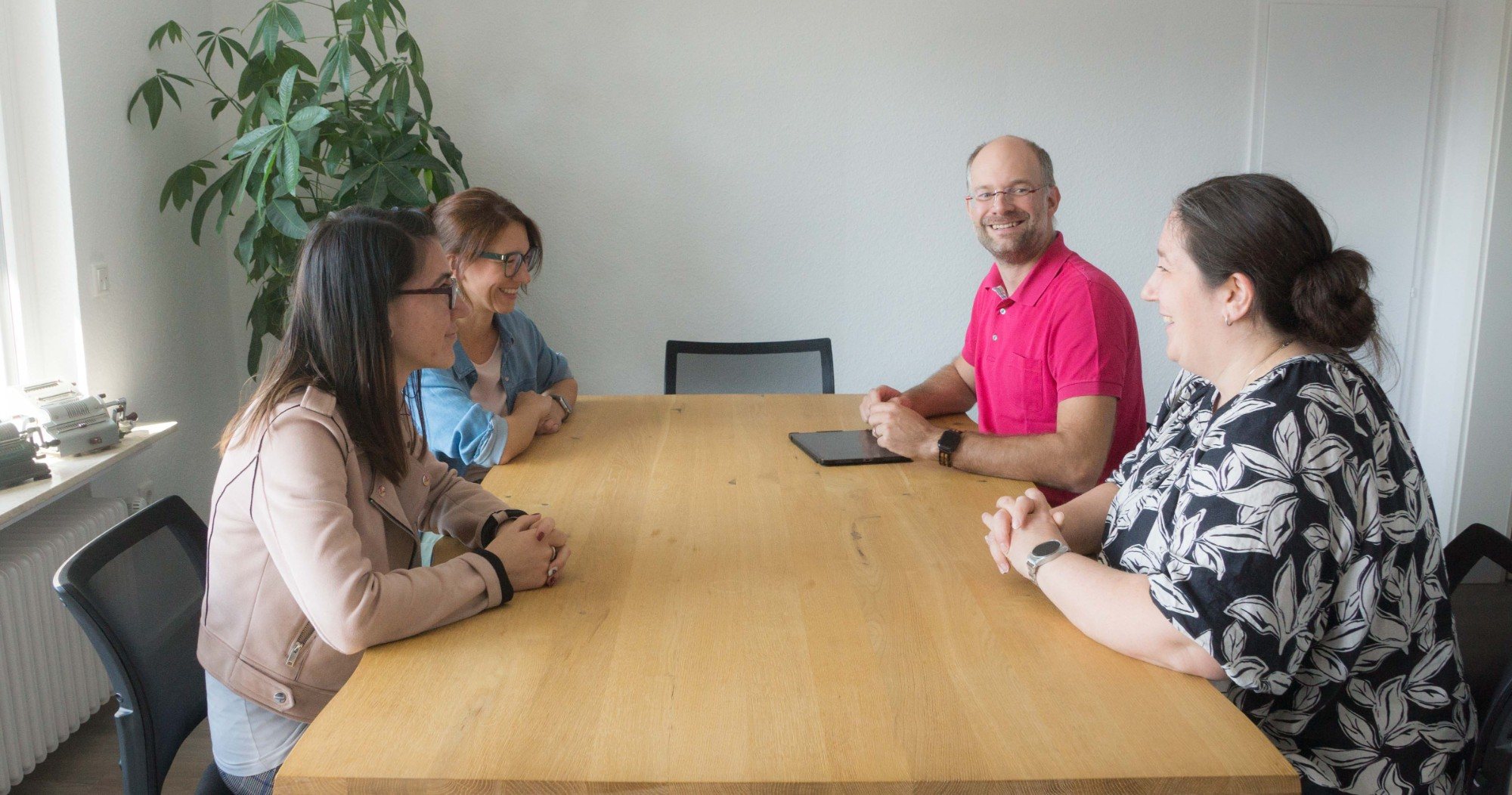 Teambesprechung am Holztisch im Besprechungsraum der Kanzlei in Neunkirchen-Seelscheid